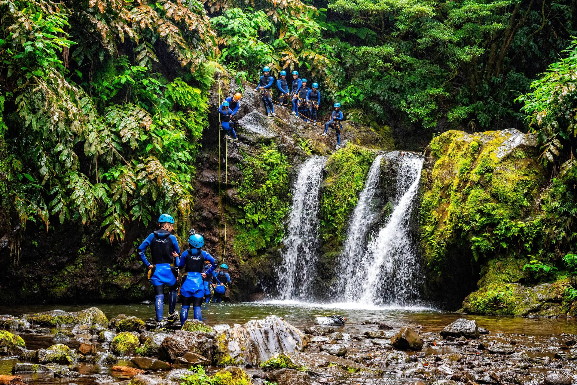 Groupe de canyoning à La Réunion Groupe équipé pour le canyoning descendant une cascade dans la forêt tropicale